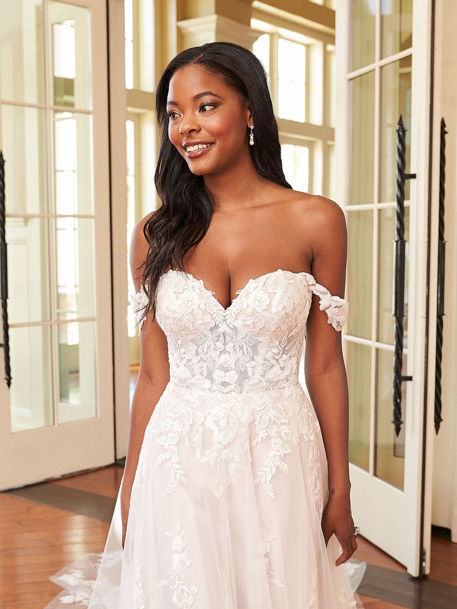 A bride smiling in her dress at Serenity Brides